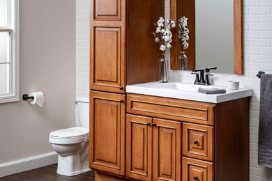 Bathroom - mid-sized traditional master white tile single-sink bathroom idea with raised-panel cabinets, medium tone wood cabinets, white countertops and a freestanding vanity