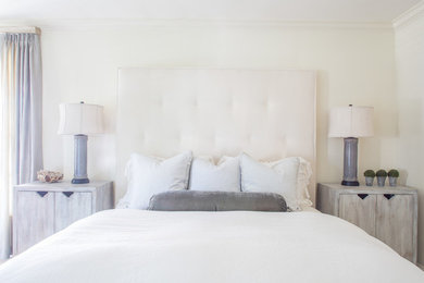 Master medium tone wood floor bedroom photo in Other with beige walls