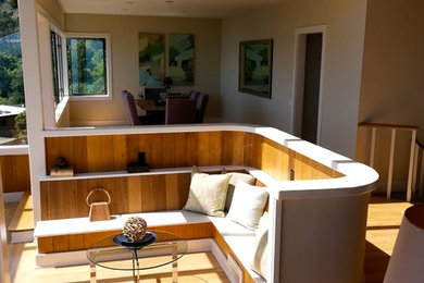 Example of a large trendy open concept light wood floor and beige floor family room design in San Francisco with gray walls, no fireplace and no tv