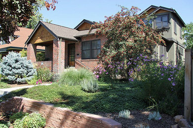 Example of a large classic green three-story mixed siding exterior home design in Denver with a hip roof