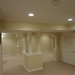 Design ideas for a large traditional basement in Baltimore with yellow walls, carpet, no fireplace and beige floors.