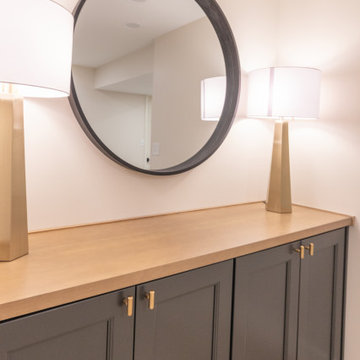 Warm & Inviting Basement Retreat with Custom Bar + Entertainment Center