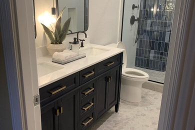 Mid-sized trendy 3/4 blue tile mosaic tile floor, double-sink and gray floor doorless shower photo in Los Angeles with blue cabinets, a one-piece toilet, white walls, a hinged shower door, a built-in vanity, flat-panel cabinets, quartz countertops and white countertops
