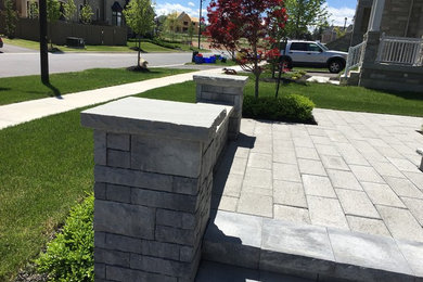 Design ideas for a mid-sized traditional front yard concrete paver landscaping in Toronto.