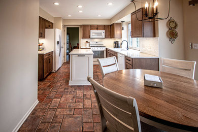 Mid-sized transitional galley eat-in kitchen photo with an undermount sink, flat-panel cabinets, medium tone wood cabinets, quartz countertops, white backsplash, ceramic backsplash, white appliances, an island and white countertops
