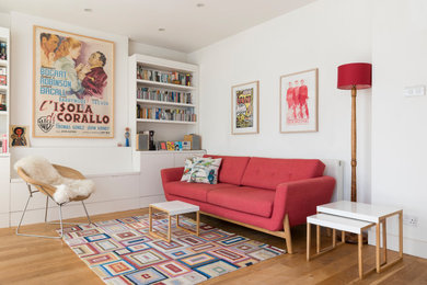 Modelo de salón abierto minimalista de tamaño medio sin chimenea y televisor con paredes blancas y suelo de madera en tonos medios