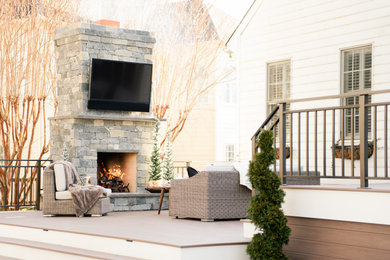 Example of a large classic backyard metal railing deck design in Richmond with a fireplace and no cover