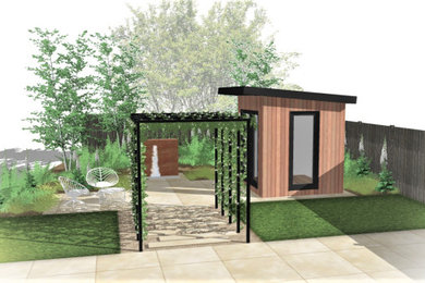 This is an example of a medium sized contemporary back partial sun garden in Gloucestershire with a wood fence.