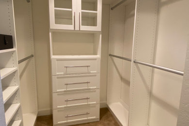 Inspiration for a mid-sized contemporary gender-neutral walk-in closet remodel in Other with recessed-panel cabinets and white cabinets