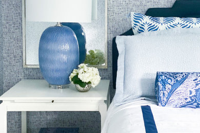 Bedroom - small transitional guest carpeted, beige floor and wallpaper bedroom idea in New York with blue walls