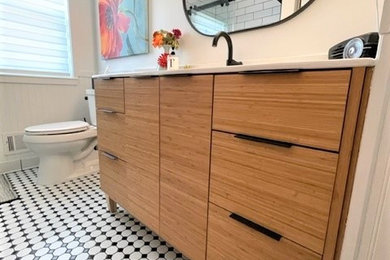 Inspiration for a small contemporary white tile and subway tile mosaic tile floor, multicolored floor and single-sink bathroom remodel in Detroit with flat-panel cabinets, light wood cabinets, a two-piece toilet, white walls, an integrated sink, solid surface countertops, white countertops and a freestanding vanity