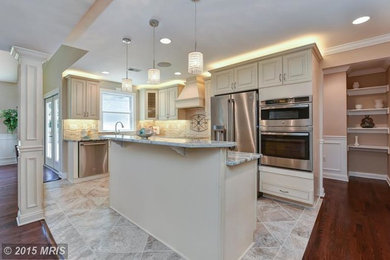 Inspiration for a large cottage l-shaped ceramic tile eat-in kitchen remodel in DC Metro with raised-panel cabinets, white cabinets, granite countertops, beige backsplash, ceramic backsplash, stainless steel appliances, an island and an undermount sink