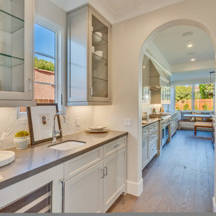Transitional kitchen pantry designs - Transitional single-wall light wood floor and beige floor kitchen pantry photo in Los Angeles with an undermount sink, recessed-panel cabinets, beige cabinets and white backsplash
