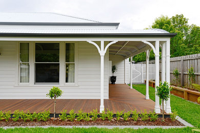Inspiration for a large traditional front yard verandah in Geelong with decking.