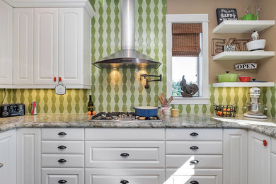 Trendy dark wood floor eat-in kitchen photo in Portland with an undermount sink, raised-panel cabinets, white cabinets, granite countertops, green backsplash, ceramic backsplash, stainless steel appliances and an island
