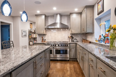 Design ideas for a large transitional l-shaped separate kitchen in Philadelphia with an undermount sink, recessed-panel cabinets, grey cabinets, granite benchtops, grey splashback, ceramic splashback, stainless steel appliances, medium hardwood floors, with island and grey benchtop.