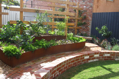Inspiration for an eclectic shaded garden in Melbourne with a garden path and brick pavers.