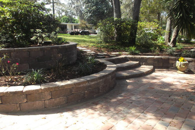 Design ideas for a mediterranean shade front yard concrete paver retaining wall landscape in Jacksonville for spring.