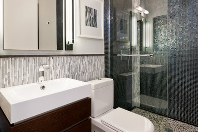 Inspiration for a small contemporary master black tile and mosaic tile marble floor doorless shower remodel in New York with a wall-mount sink, flat-panel cabinets, dark wood cabinets, a one-piece toilet and gray walls
