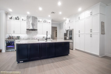 This is an example of a large traditional l-shaped kitchen pantry in Orlando with recessed-panel cabinets, white cabinets, engineered stone countertops, white splashback, ceramic splashback, porcelain flooring, an island, beige floors and multicoloured worktops.