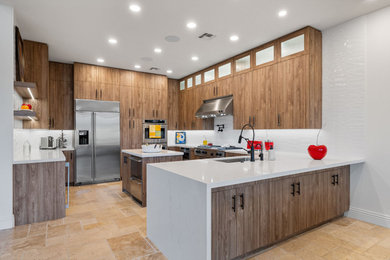 Inspiration for a rustic l-shaped slate floor and beige floor enclosed kitchen remodel in Other with a single-bowl sink, flat-panel cabinets, medium tone wood cabinets, quartzite countertops, white backsplash, glass sheet backsplash, stainless steel appliances, a peninsula and white countertops