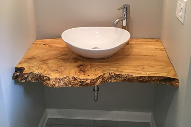 Inspiration for a mid-sized rustic gray floor and porcelain tile bathroom remodel in DC Metro with gray walls, a vessel sink and wood countertops