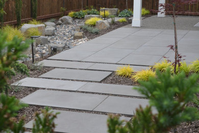 Photo of a small asian partial sun backyard concrete paver and wood fence garden path in Other for summer.