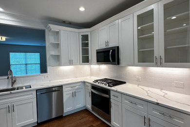Inspiration for a timeless kitchen remodel with white backsplash and stainless steel appliances