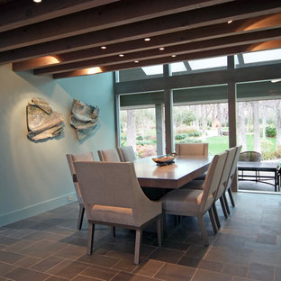 This is an example of a contemporary dining room in Dallas with slate flooring.