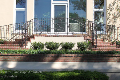 Photo of a mid-sized mediterranean full sun side yard brick formal garden in Louisville for summer.