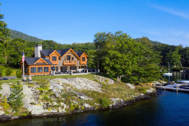 Large arts and crafts three-story mixed siding exterior home photo in New York