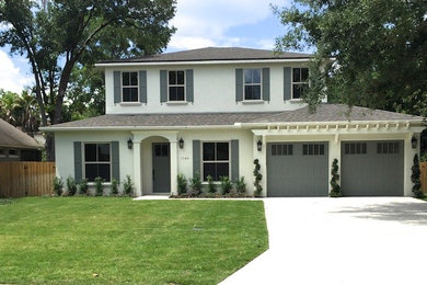 This is an example of a large transitional two-storey stucco beige exterior in Orlando with a hip roof.