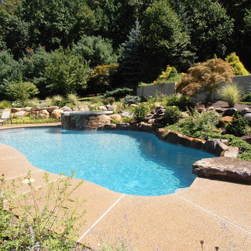 Upper Saucon Township custom built pool with raised spa, waterfall, & boulders
