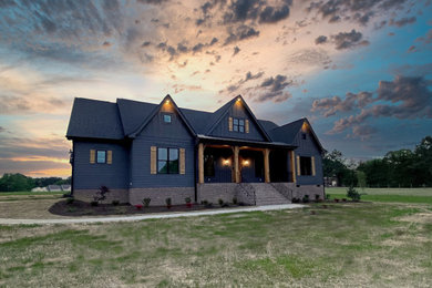 Example of a cottage gray one-story concrete fiberboard house exterior design in Raleigh with a black roof