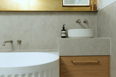 オークランドにあるおしゃれな浴室 (フローティング洗面台、コーナー型浴槽、緑のタイル、ベッセル式洗面器、グレーの床、フラットパネル扉のキャビネット) の写真