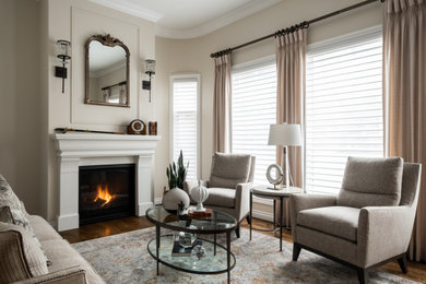 エドモントンにある高級な広いトランジショナルスタイルのおしゃれなLDK (濃色無垢フローリング、標準型暖炉、漆喰の暖炉まわり、テレビなし、茶色い床) の写真