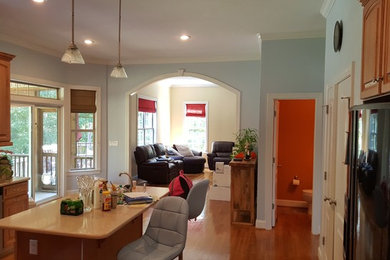 Inspiration for a mid-sized timeless l-shaped medium tone wood floor enclosed kitchen remodel in Raleigh with raised-panel cabinets, medium tone wood cabinets, granite countertops, ceramic backsplash and an island