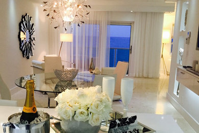 Example of a mid-sized trendy marble floor kitchen/dining room combo design in Miami with beige walls and no fireplace