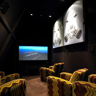 Expansive eclectic enclosed home cinema in Manchester with grey walls, carpet and a wall mounted tv.