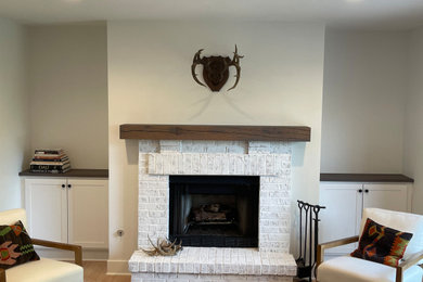 Inspiration for a small contemporary family room remodel in Chicago with a standard fireplace and a brick fireplace