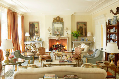 Elegant formal medium tone wood floor living room photo in Richmond with yellow walls, a standard fireplace, a plaster fireplace and no tv