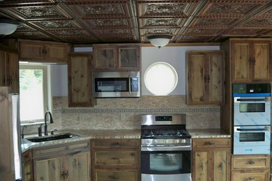 Inspiration for a rustic eat-in kitchen remodel in Seattle with flat-panel cabinets