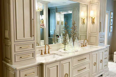 Photo of a large transitional master bathroom in Other with beaded inset cabinets, grey cabinets, a curbless shower, a two-piece toilet, beige walls, porcelain floors, an undermount sink, engineered quartz benchtops, beige floor, a hinged shower door, beige benchtops, an enclosed toilet, a double vanity and a freestanding vanity.