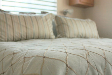 Small trendy master carpeted bedroom photo in Miami with beige walls