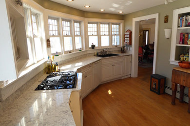 Inspiration for a timeless single-wall enclosed kitchen remodel in Manchester with a drop-in sink, raised-panel cabinets, white cabinets, quartz countertops and no island