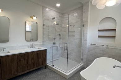 Large minimalist master gray tile and ceramic tile ceramic tile, gray floor and double-sink bathroom photo in Philadelphia with furniture-like cabinets, brown cabinets, a two-piece toilet, beige walls, quartz countertops, a hinged shower door, white countertops and a freestanding vanity