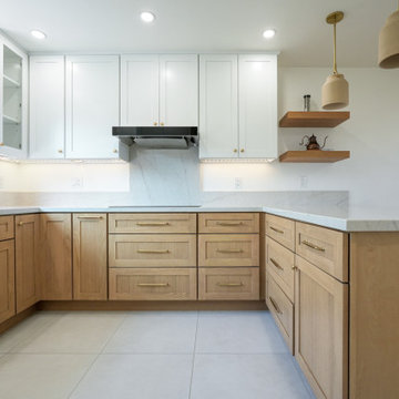 Modern White and Natural Oak Kitchen with Brass Hardware and Quartz Backsplash