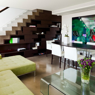 This is an example of a contemporary look-out basement in Vancouver with white walls, no fireplace and concrete flooring.