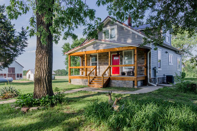 Small farmhouse gray two-story concrete fiberboard exterior home photo in St Louis with a metal roof