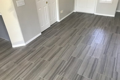 Example of a minimalist ceramic tile and gray floor living room design in Phoenix with white walls
